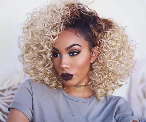 Fierce look with platinum blonde curls and dark roots